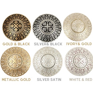May include: Six decorative round placemats with intricate designs. The placemats are available in gold and black, silver and black, ivory and gold, metallic gold, silver satin, and white and red.
