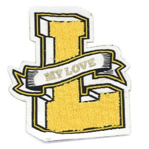 May include: Yellow felt letter L with a black outline and a white banner that says "MY LOVE" in gold lettering. The letter is in a 3D style.