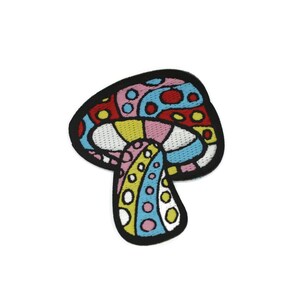 May include: A colourful embroidered patch of a mushroom with a pink, red, yellow, blue and white design.