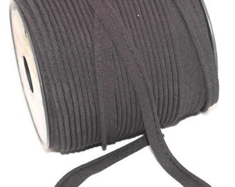 May include: A spool of black suede cord, wound tightly and ready for crafting projects.