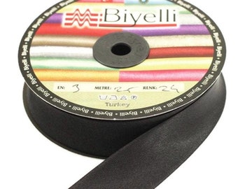 May include: A spool of black satin ribbon with a label that reads "Biyelli" and includes the text "EN: 3 METRE: 24 RENK: 24 Turkey VAA".