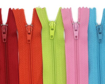 May include: Assortment of zipper tapes in various colors, including red, orange, green, pink, blue, and purple. The zippers are closed and ready to be sewn into a project.