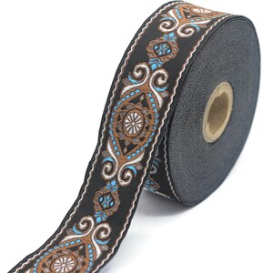 May include: Black and brown trim with a blue and white floral pattern. The trim is rolled up on a spool.