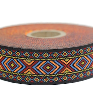 May include: A roll of black trim with a colourful geometric pattern. The pattern features red, orange, yellow, blue, and green colours. The trim is approximately 2.5 cm wide.