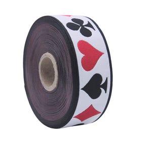 May include: A roll of white and black ribbon with red playing card symbols printed on it. The symbols are a club, a heart, a spade, and a diamond.