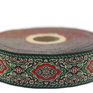 Puede incluir: Un rollo de ribete negro, verde y rojo con un diseño floral.