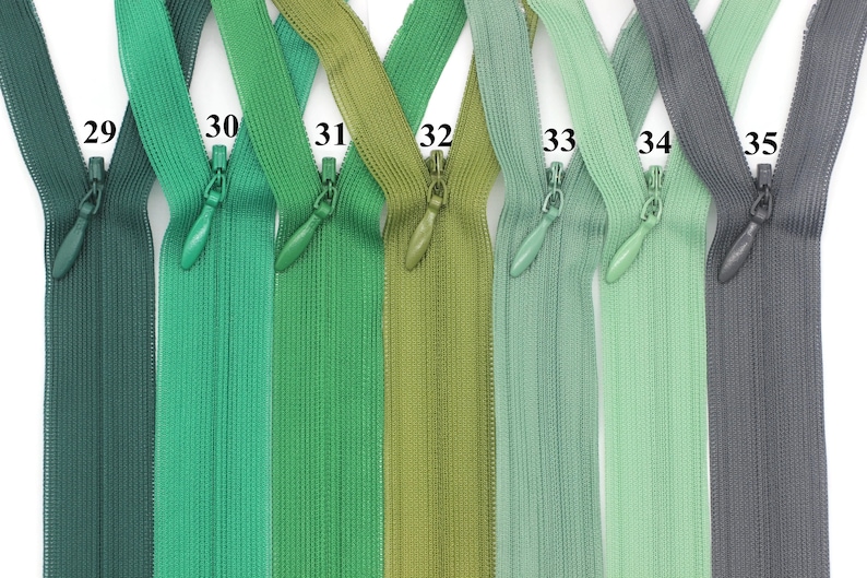 May include: Seven different colors of zipper tape, ranging from dark green to gray. The zipper tape is labeled with numbers 29 through 35.