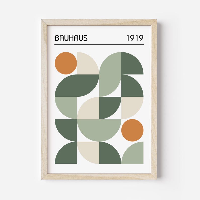 May include: Framed Bauhaus art print featuring a geometric design in shades of green, beige, and orange. The print includes the word "BAUHAUS" and the year "1919" in a minimalist font, set against a white background.