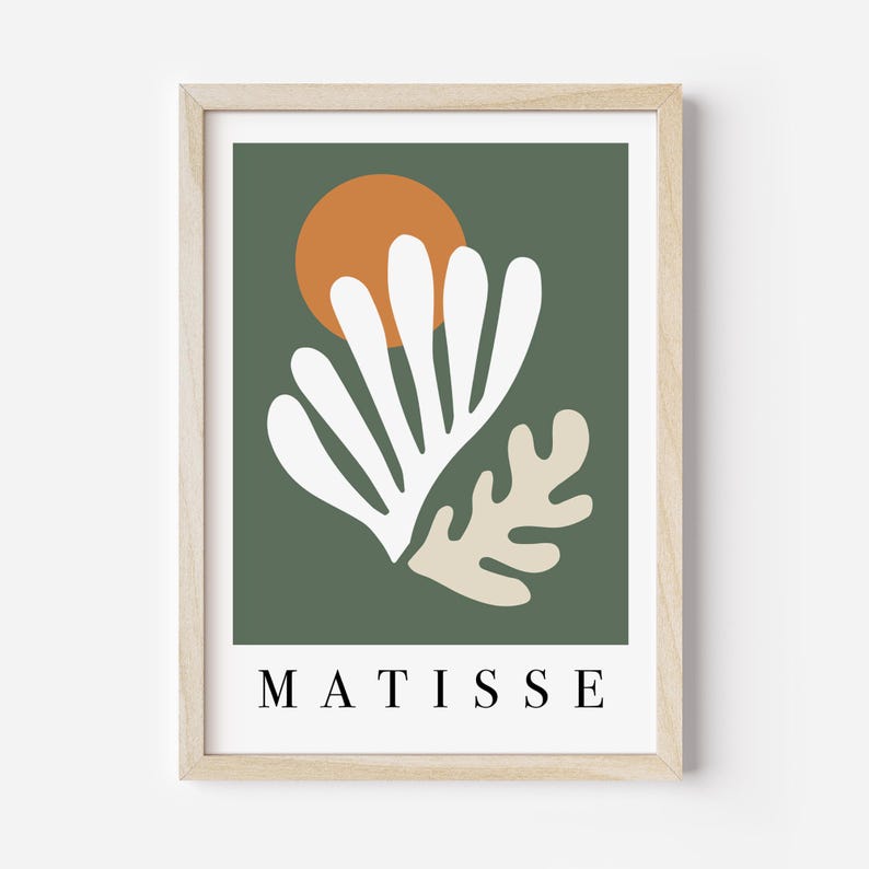 May include: A framed art print featuring a minimalist design. The artwork showcases white and beige organic shapes against a dark green background, with an orange circle resembling a sun. The word "MATISSE" is printed in black at the bottom.