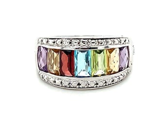 May include: A silver ring with a row of colorful gemstones, including amethyst, citrine, garnet, aquamarine, peridot, and topaz, set in a band of pave diamonds.