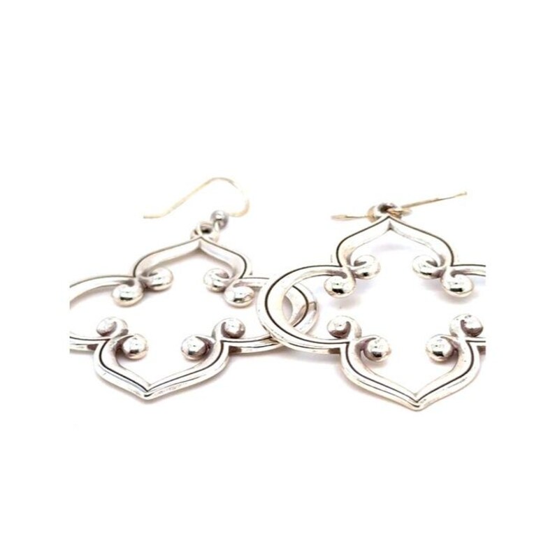 May include: A pair of silver earrings with an openwork quatrefoil design. Each earring has small, round accents and a hook closure. The earrings are displayed against a white background. The design is symmetrical.