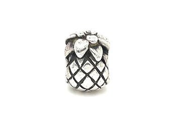 May include: A silver-colored charm in the shape of a pineapple. The charm has a textured, diamond-patterned body and a leafy top. The pineapple charm is a jewelry component.