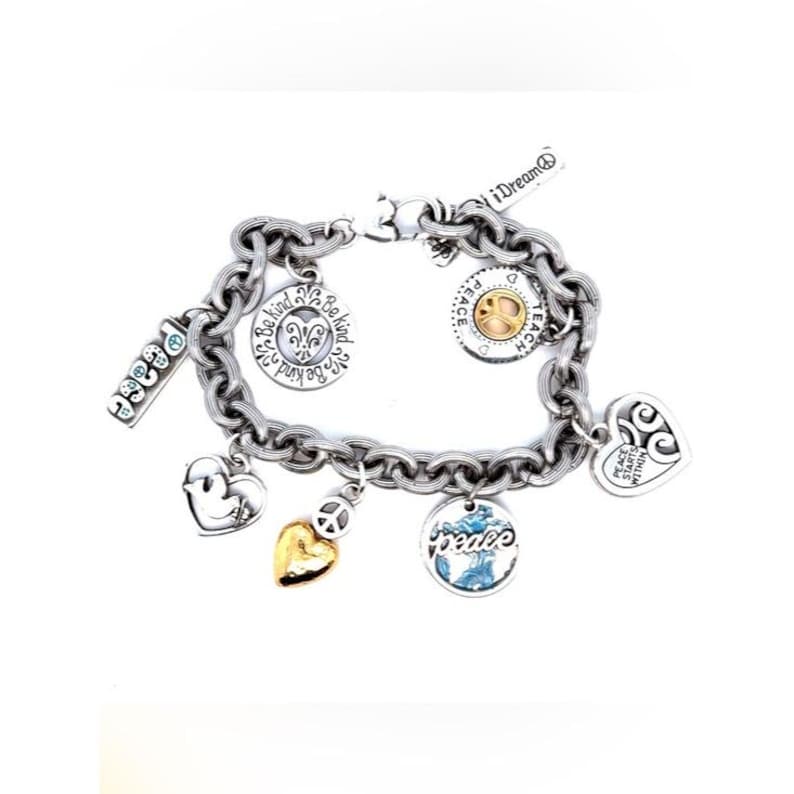 May include: Silver-toned charm bracelet with multiple charms. Charms include hearts, a peace sign, and a round charm with the word "peace" and a globe design. Other charms have the words "Be Kind" and "iDream".