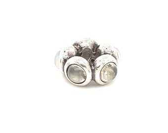 May include: Silver charm with five white stones set in a flower shape.