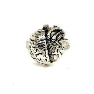 May include: A silver-colored ring featuring a detailed design of a brain and a heart side-by-side. The ring has a textured surface, with the brain and heart elements clearly defined. The ring is likely made of metal and is set against a white background.
