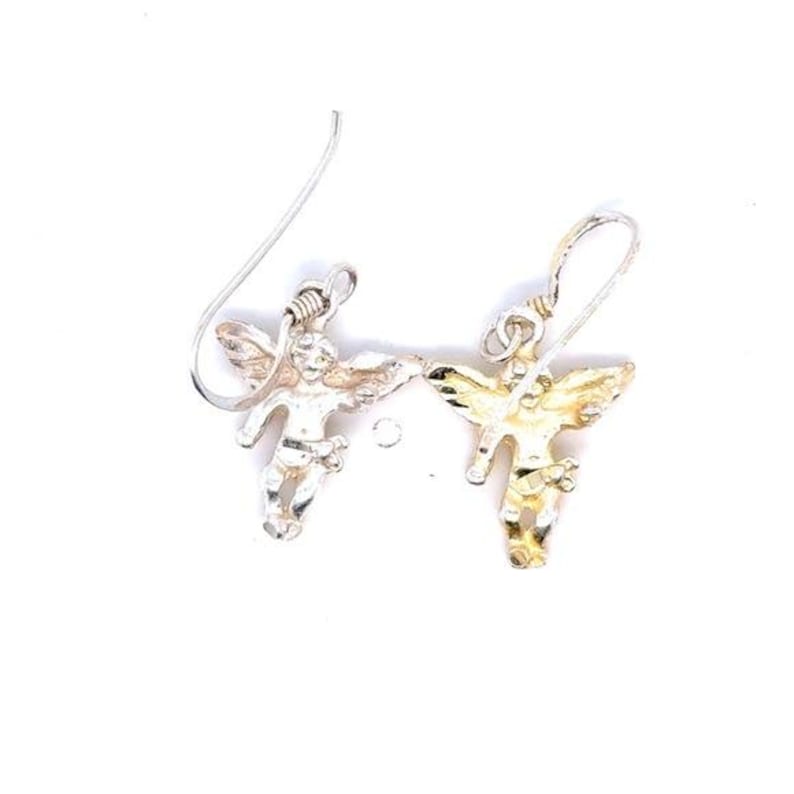 May include: A pair of silver-toned angel earrings. Each earring features a small, detailed angel figure with outstretched wings, suspended from a simple hook. The angels have a textured appearance, and the earrings are set against a white background.
