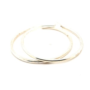 May include: A pair of polished silver-tone hoop earrings with a smooth, circular design. The earrings feature a thin, lightweight metal construction with a reflective finish and a simple, continuous loop shape that overlaps slightly.