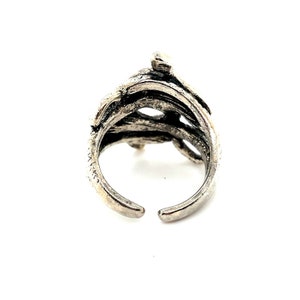 K&ouml;nnte beinhalten: Ein silberner Ring mit einem einzigartigen, organischen Design, das an &Auml;ste oder Ranken erinnert. Der Ring ist offen und verstellbar.