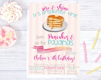 May include: Pink and blue invitation for a child's birthday party. The invitation features a stack of pancakes with butter and syrup, and the text "rise & shine it's breakfast time". The invitation also includes the text "Join us for Pancakes & Pajamas in celebration of Chelsea's 5th birthday!" and the date "Saturday, August 4, 2018".