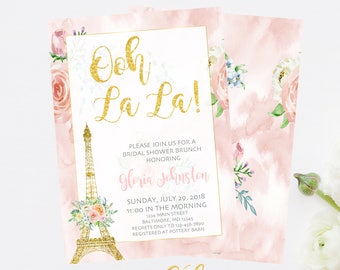 May include: A pink and gold bridal shower invitation with a watercolor floral design and a gold Eiffel Tower. The invitation reads "Ooh La La!" and includes the text "Please join us for a bridal shower brunch honoring Gloria Johnston" and details for the event.