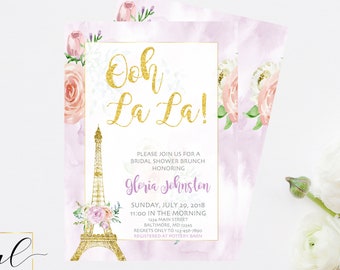 May include: A pink and purple watercolor background with a gold Eiffel Tower and floral accents. The text "Ooh La La!" is written in gold glitter. The invitation reads "Please join us for a bridal shower brunch honoring Gloria Johnston. Sunday, July 29, 2018, 11:00 in the morning, 1234 Main Street, Baltimore, MD 2345. Regrets only to 1234-7800. Registered at Pottery Barn."