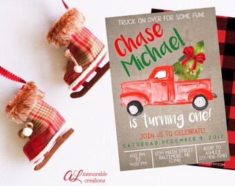 May include: A red and green Christmas-themed invitation for a first birthday party. The invitation features a red truck with a Christmas tree in the back. The text on the invitation reads "Chase Michael is turning one!" and includes the date and time of the party.