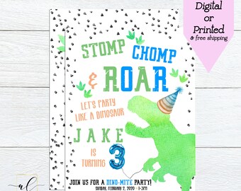 May include: A green dinosaur with a party hat is featured on a birthday invitation for a boy turning three. The invitation has a white background with black and green confetti. The text on the invitation reads "Stomp, Chomp & Roar! Let's party like a dinosaur. Jake is turning 3. Join us for a Dino-mite party!"