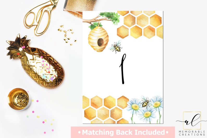 May include: A printable honeybee themed table number card with a watercolor illustration of a honeycomb, a beehive, and a bee. The number one is written in black script. The text "Matching Back Included" is at the bottom of the card.