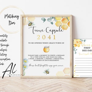 May include: A printable time capsule sign with a yellow honeycomb pattern, a bee, and a jar of honey. The sign says "Time Capsule 2041" and "To be opened when Grace turns 18!"  There is a smaller card with a bee and honeycomb pattern that says "Grace's First Bee-Day Time Capsule Message".
