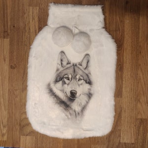 May include: White faux fur hot water bottle with a grey wolf print and two white pom-poms.