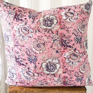 May include: Pink floral pillow cover with a white and blue floral pattern. The pillow cover is made of a soft, cotton fabric and is perfect for adding a touch of color and style to any room.