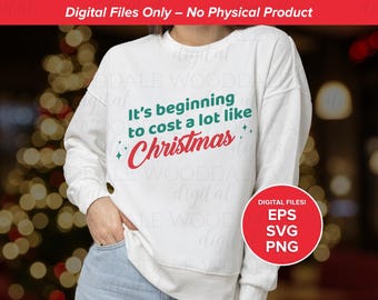 May include: White sweatshirt with the text "It's beginning to cost a lot like Christmas" in green and red. A red circle with white text that says "Digital Files! EPS SVG PNG" is in the bottom right corner. The background is blurred.