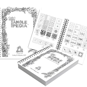 May include: Three spiral-bound books titled "Cathy's Tangle Pedia" are displayed. The covers and pages feature intricate black and white line art, including floral and geometric patterns. The open book reveals examples of Zentangle patterns.