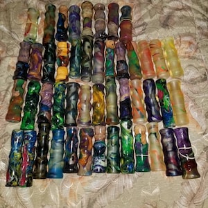 May include: A collection of colourful, hand-turned, wooden pen blanks. The blanks are made of various types of wood and have a variety of patterns and colours.