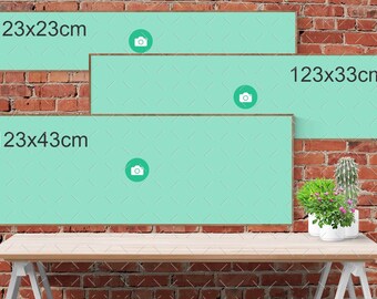 Op de afbeelding: Drie turquoise ingelijste canvasdoeken met de afmetingen 123x23cm, 123x33cm en 123x43cm. De canvasdoeken hangen aan een bakstenen muur met een houten tafel ervoor.