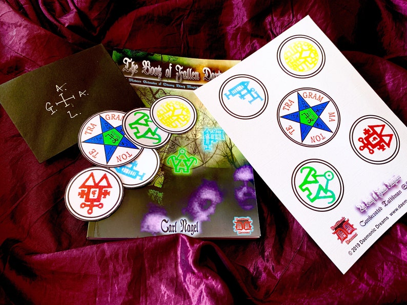 May include: A book titled "The Book of Fallen Darkness: Western Grimoire of Strong Magick" by Carl Nagel with a set of colorful stickers featuring various symbols and the text "Consecrated Talisman &copy;2019 Daemonic Dreams www.daemonicdreams.com"