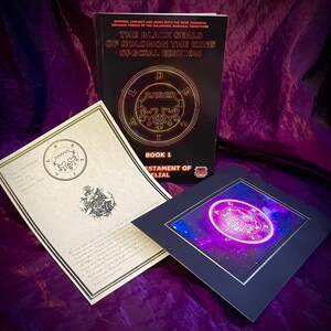 May include: A black book titled "The Black Seals of Solomon the King Special Edition" with a gold seal on the cover. The book is open to a page with the text "Book 1 Testament of Elial". There is a white certificate with a gold seal and a black framed print with a purple seal on a purple background.