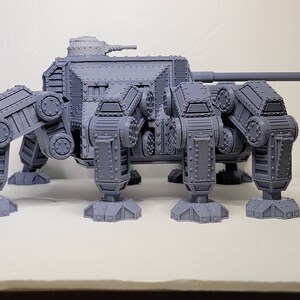 May include: A gray, 3D printed, six-legged, tank-like model with a large cannon on top.