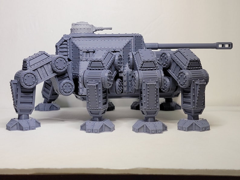 May include: A gray, 3D printed, six-legged, tank-like model with a large cannon on top.