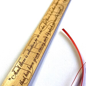 May include: Wooden bookmark with a red ribbon. The bookmark has a quote from the Bible, Acts 4:12, "And there is salvation in no one else, for there is no other name under heaven given among men by which we must be saved."