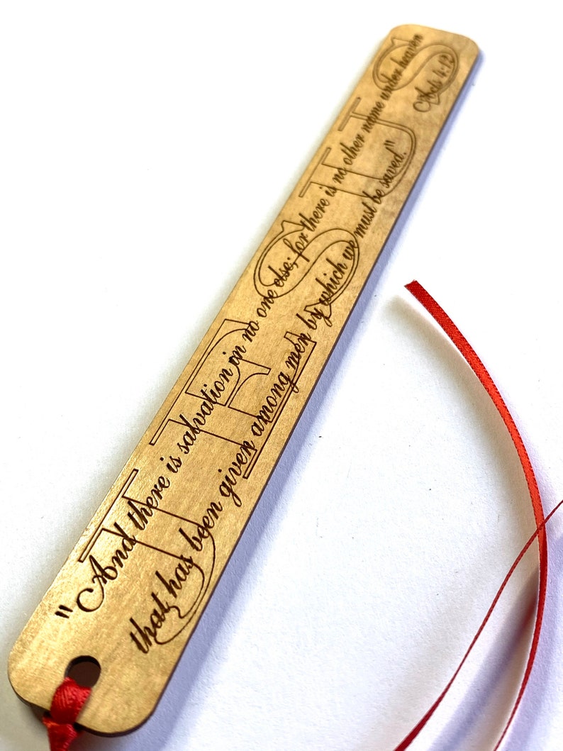 May include: Wooden bookmark with a red ribbon. The bookmark has a quote from the Bible, Acts 4:12, "And there is salvation in no one else, for there is no other name under heaven given among men by which we must be saved."