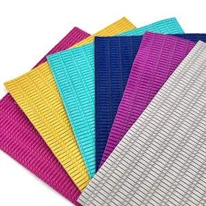 May include: Six sheets of textured craft paper in various colors, including gray, purple, blue, turquoise, yellow, and pink.