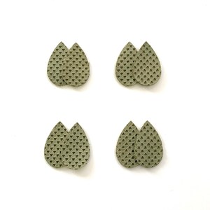 May include: Four pairs of green teardrop-shaped earrings with a geometric pattern. The earrings are made of leather and have a textured surface.