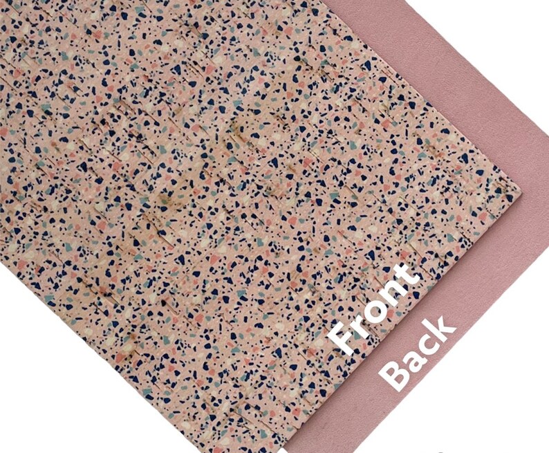 May include: A sheet of pink and white patterned faux leather with a terrazzo design. The back side of the sheet is a solid pink color. "Front" and "Back" are written on the sheet.