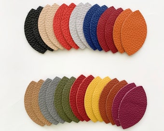 May include: Assortment of 20 leather leaf shapes in various colors, including black, red, orange, yellow, green, gray, and purple. The leaves are arranged in two rows, with the top row slightly overlapping the bottom row.