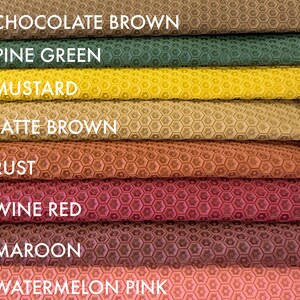 May include: Close-up of eight fabric swatches with a honeycomb pattern. The swatches are arranged in a stack from top to bottom: Chocolate Brown, Pine Green, Mustard, Latte Brown, Rust, Wine Red, Maroon, and Watermelon Pink.