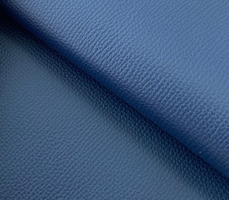 May include: Close-up of a dark blue textured leather fabric.