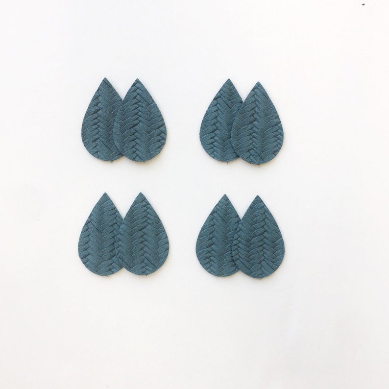 May include: Eight teal teardrop-shaped leather earring components. Each component has a woven texture. The components are arranged in pairs on a white background. These components are ideal for crafting earrings.