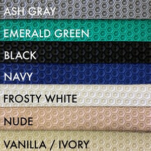 May include: A close-up of seven fabric swatches with a honeycomb pattern. The swatches are in the following colors: ash gray, emerald green, black, navy, frosty white, nude, and vanilla/ivory.