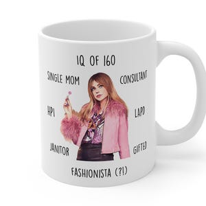 May include: White ceramic mug with a woman in a pink jacket. Text includes "IQ of 160", "Single Mom", "Consultant", "Fashionista (?!) ", "LAPD", "Gifted", "HPI", and "Janitor".